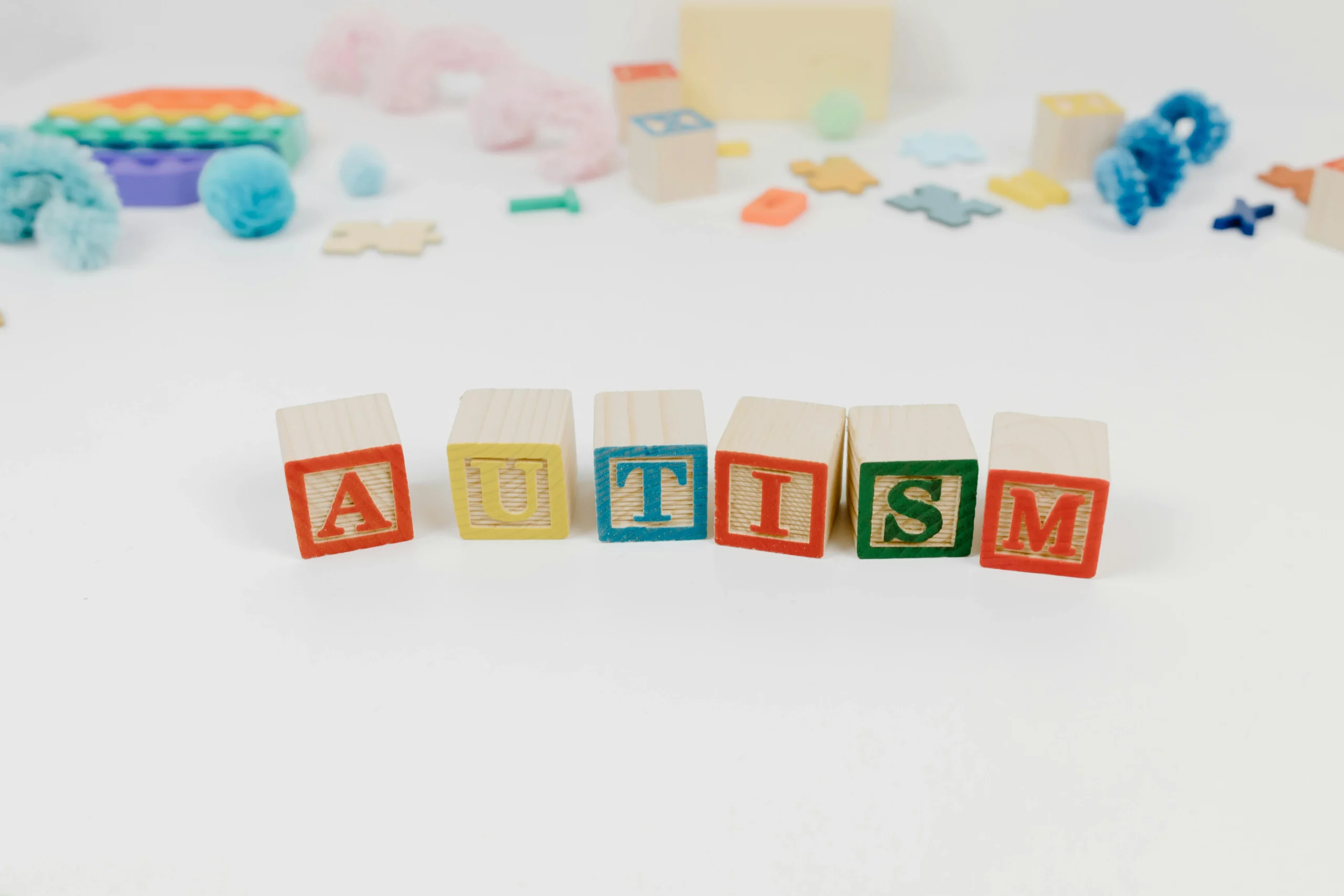 Autism awareness concept with wooden blocks, representing tools and toys for teenager with autism or calming sensory toys for autism. Autism awareness concept with wooden blocks, representing tools and toys for teenager with autism or calming sensory toys for autism.