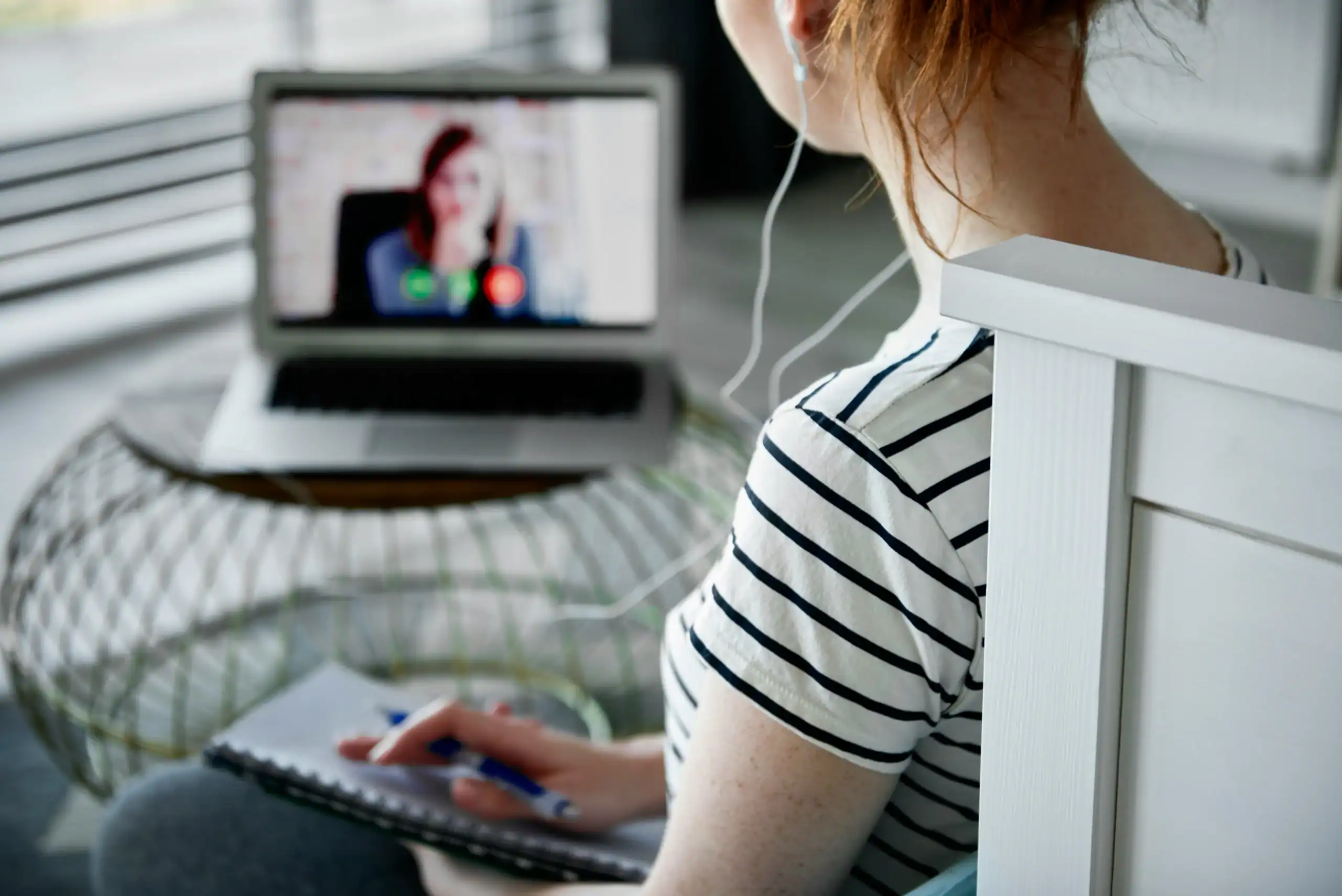 Adult woman on video call taking notes, representing adult support strategies for non verbal learning disorder vs autism Adult woman on video call taking notes, representing adult support strategies for non verbal learning disorder vs autism