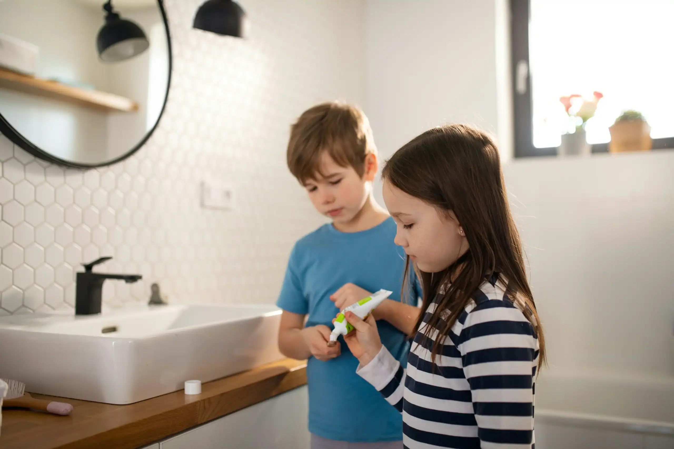 Children brushing teeth together, learning autism and hygiene routines in a shared environment Children brushing teeth together, learning autism and hygiene routines in a shared environment