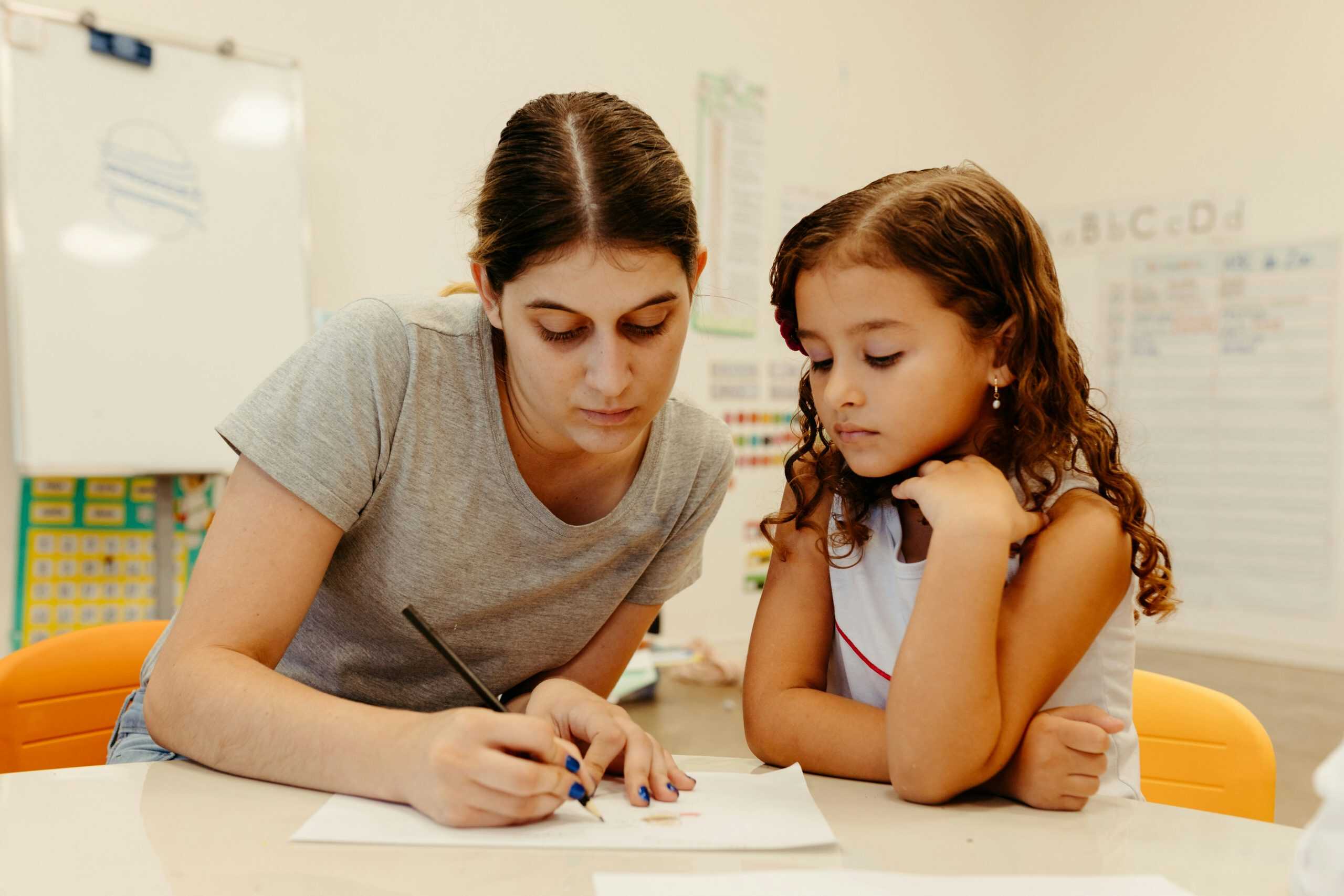 One-on-one teaching moment illustrating how IEP and 504 plans offer individualized education support for children with learning needs One-on-one teaching moment illustrating how IEP and 504 plans offer individualized education support for children with learning needs
