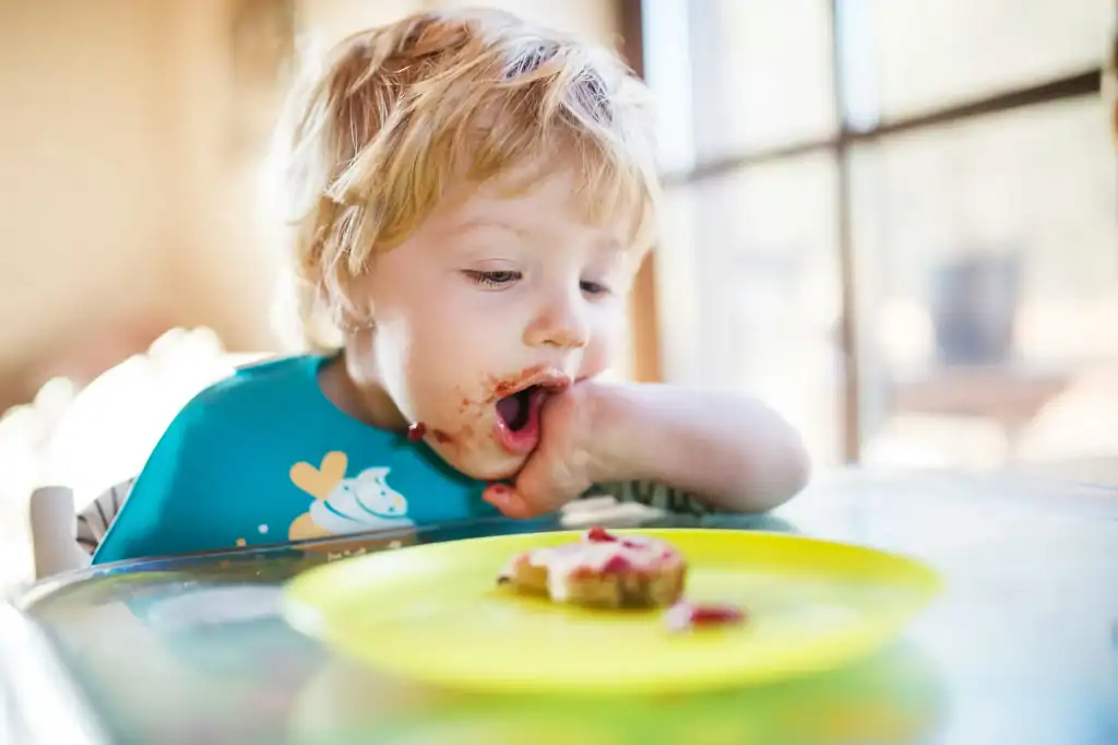 Toddler engaging with food textures during mealtime