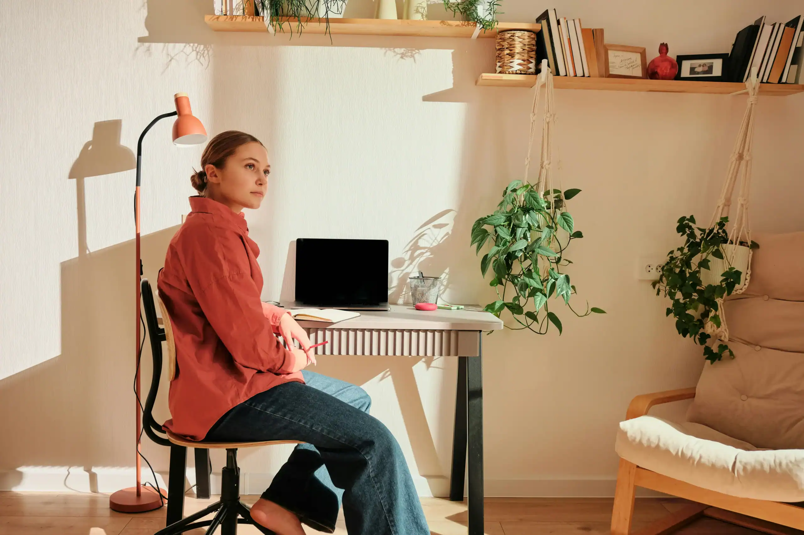Young woman sitting alone in a cozy apartment, symbolizing semi-independent living for adults with disabilities Young woman sitting alone in a cozy apartment, symbolizing semi-independent living for adults with disabilities