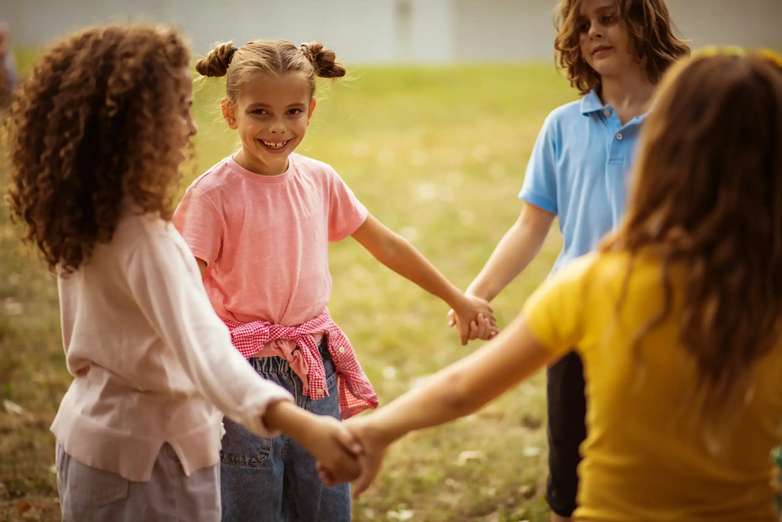 Children holding hands and supporting each other as a way how to deal with a bully together