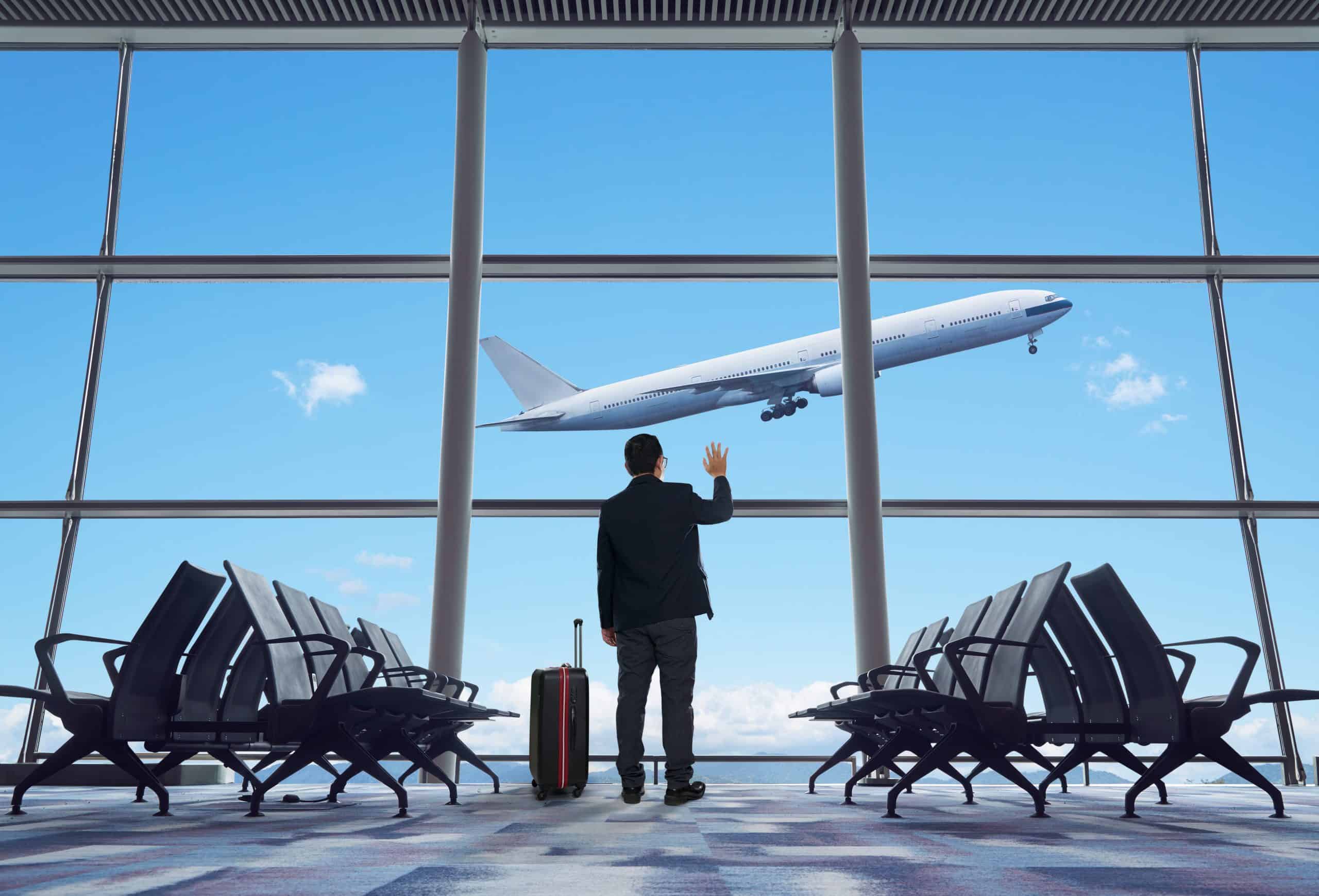 young businessman waving good bye at airport