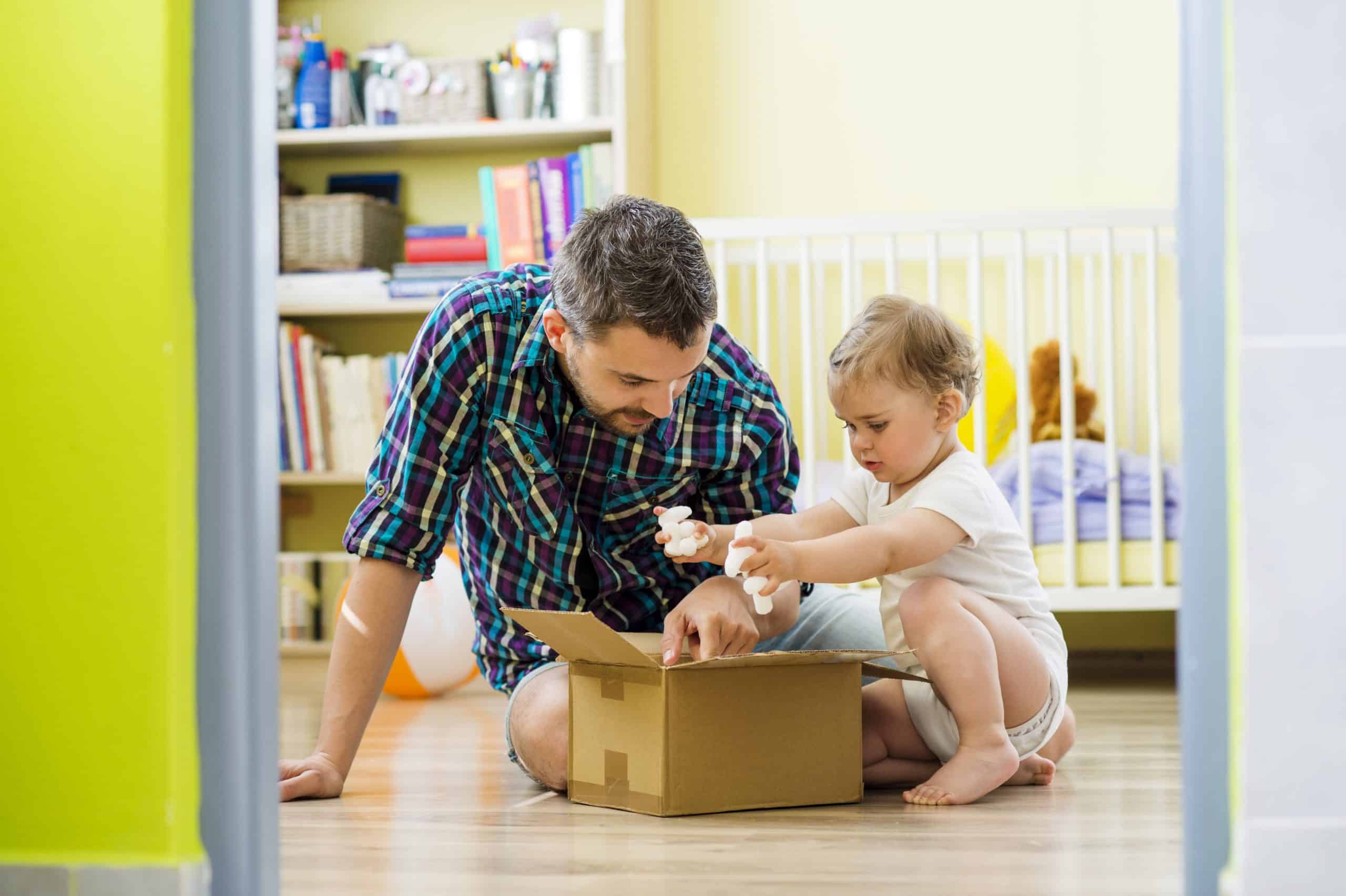 Father and daughter playing Guardianship for Special Needs - happy father and his little daughter opening box