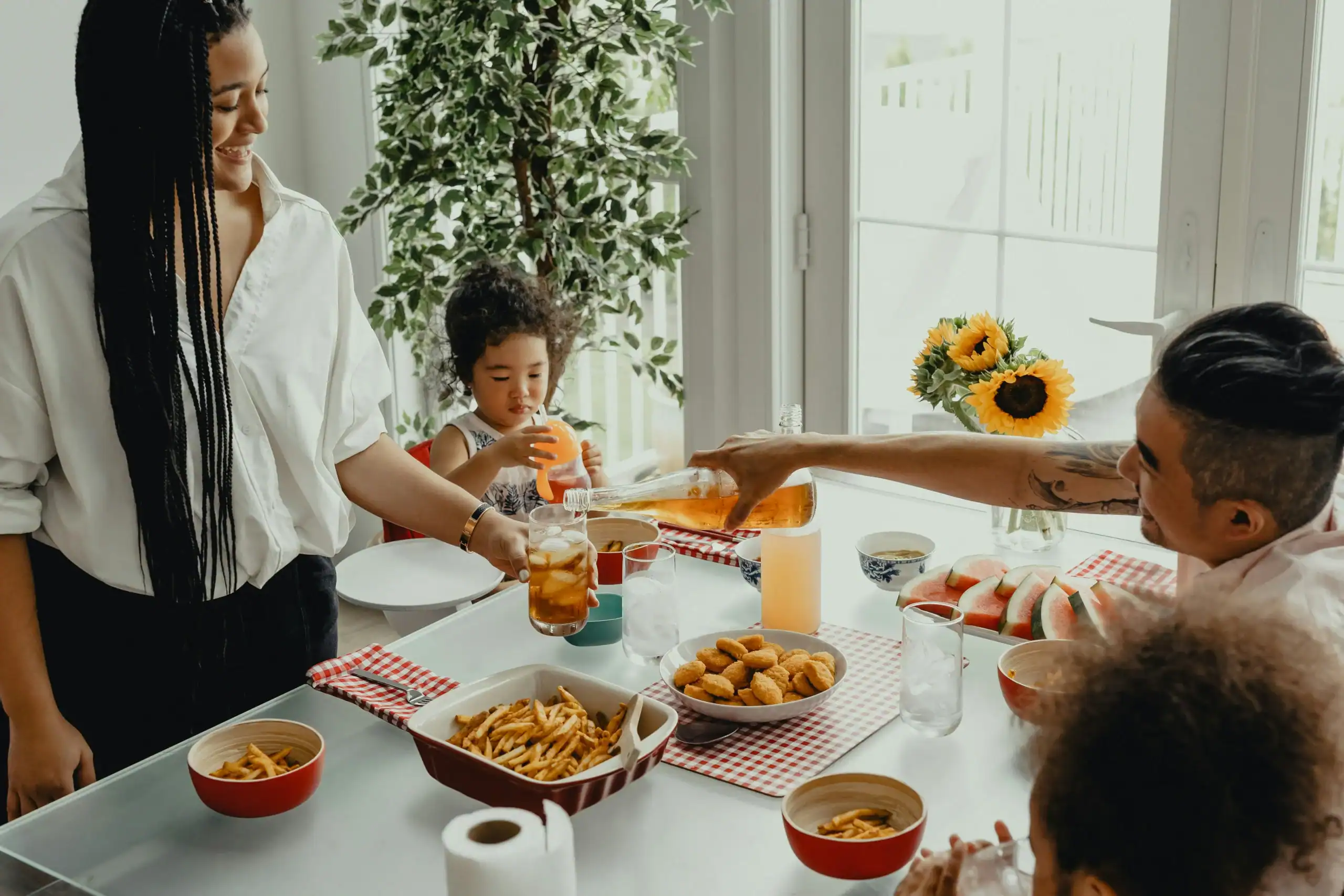 Blended family enjoying a shared meal together, overcoming blending family issues through connection and routine Blended family enjoying a shared meal together, overcoming blending family issues through connection and routine