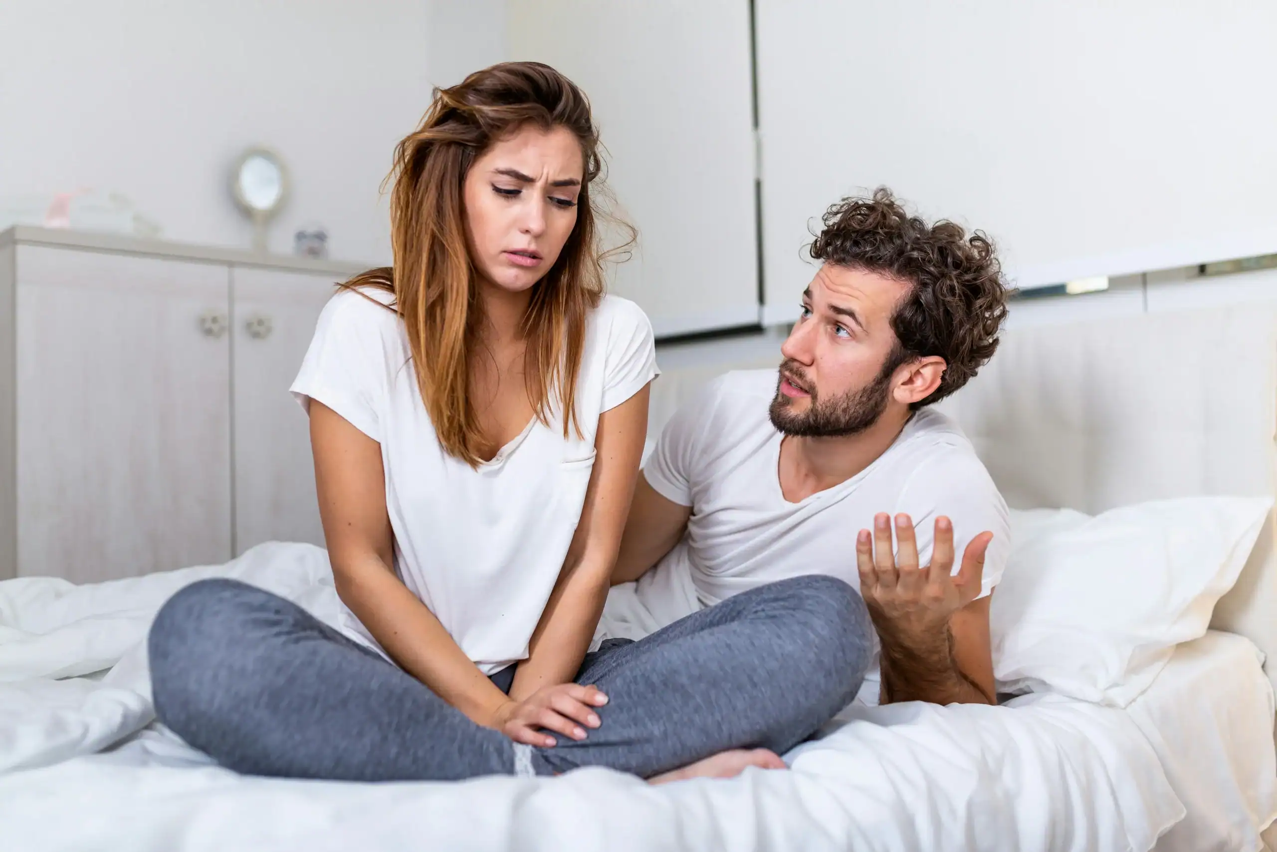 Couple discussing sleep problems in bedroom – is sleep apnea a disability Couple discussing sleep problems in bedroom – is sleep apnea a disability