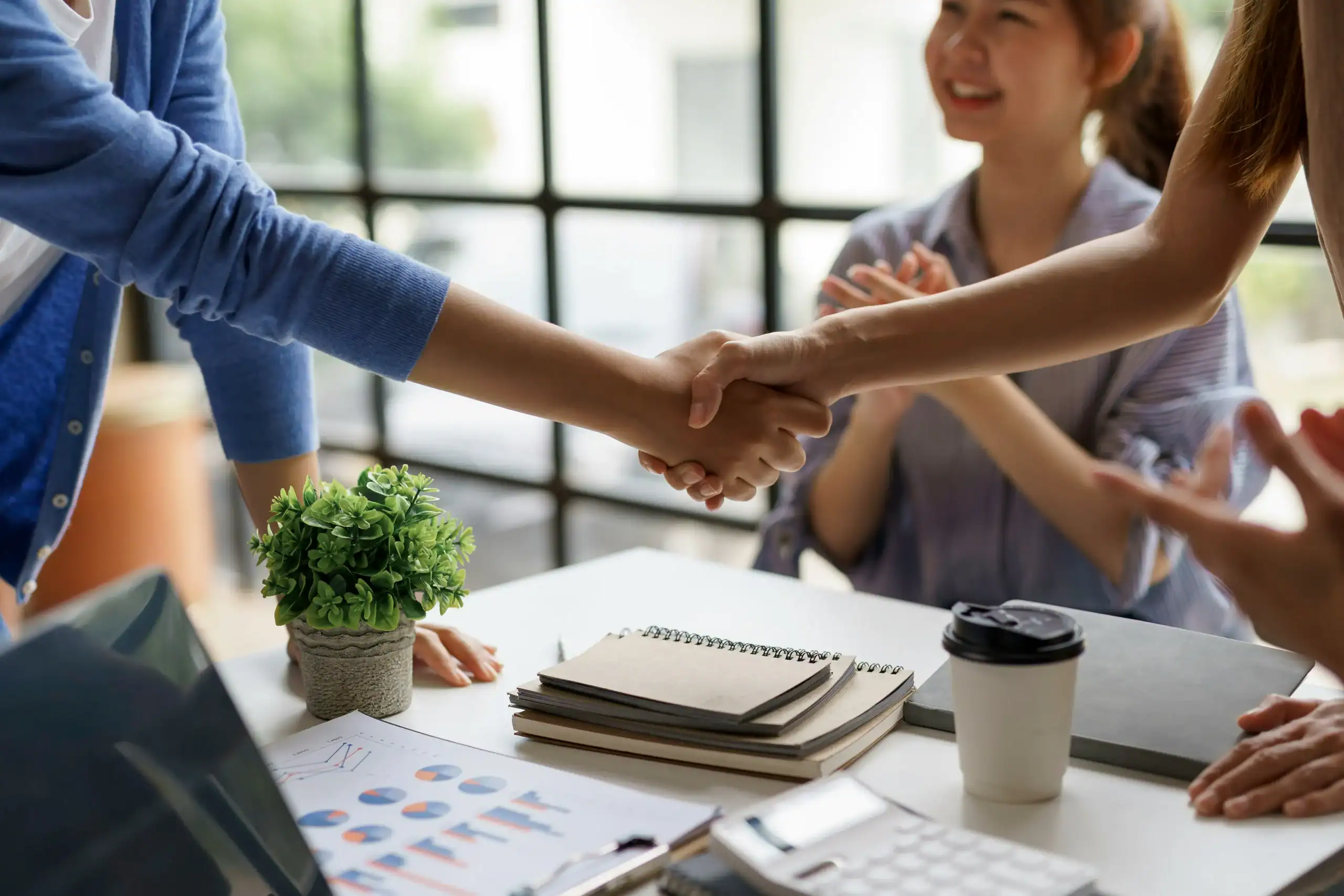 two people handshaking after a special needs trust meeting