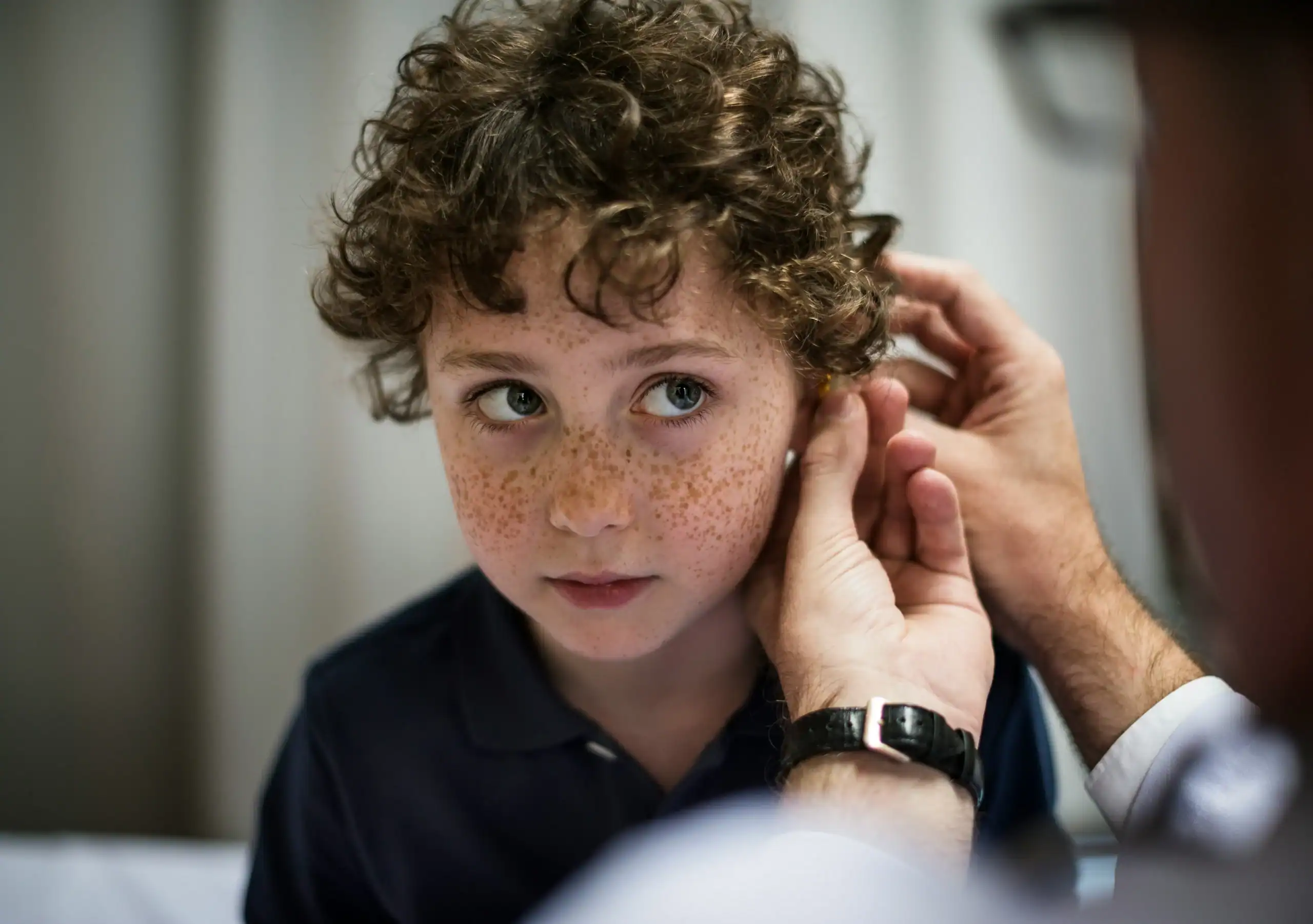 Child being fitted for hearing aid due to bilateral hearing loss