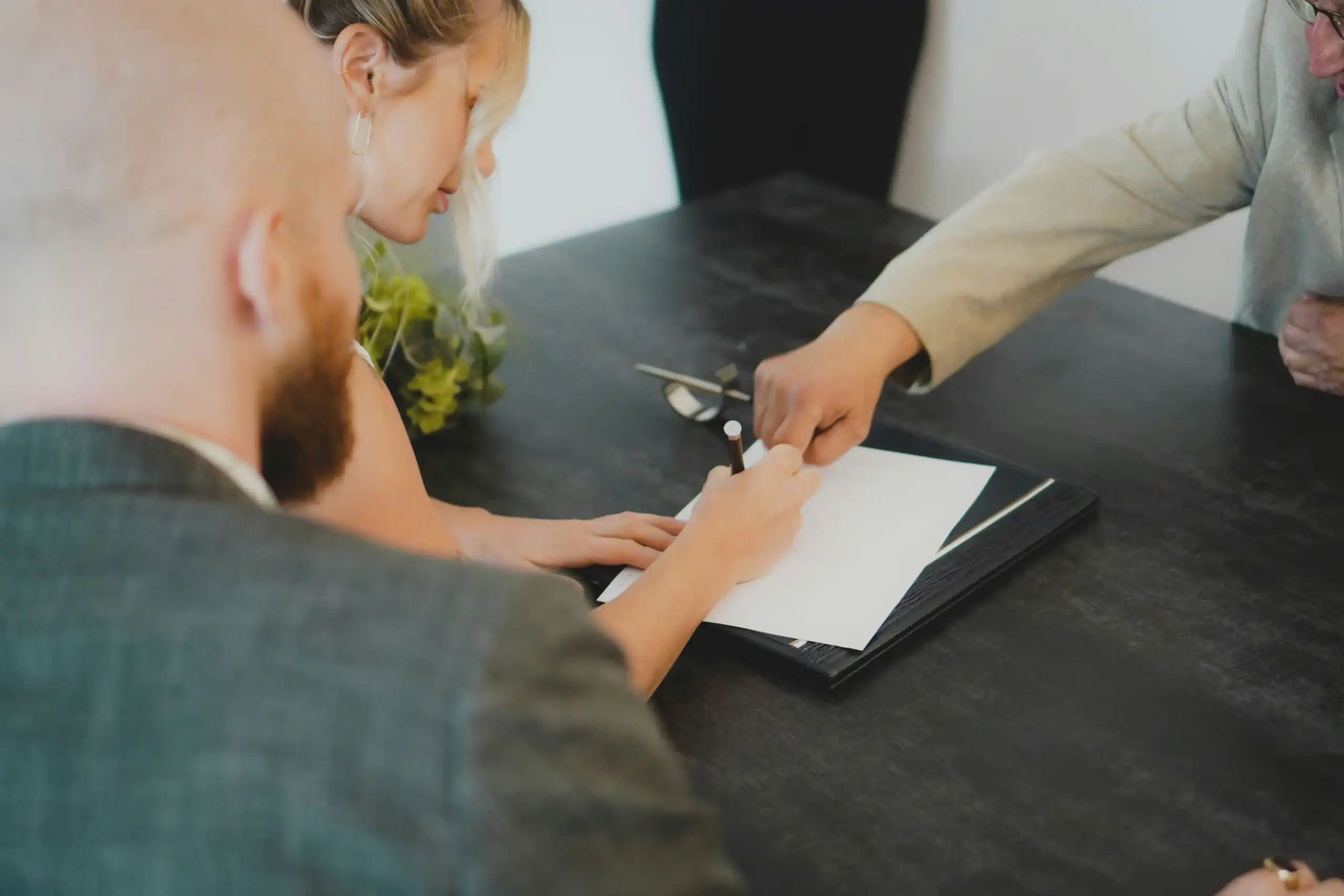 Family members signing important paperwork for estate planning and care decisions, a key responsibility for sandwich generation caregivers. Family members signing important paperwork for estate planning and care decisions, a key responsibility for sandwich generation caregivers.