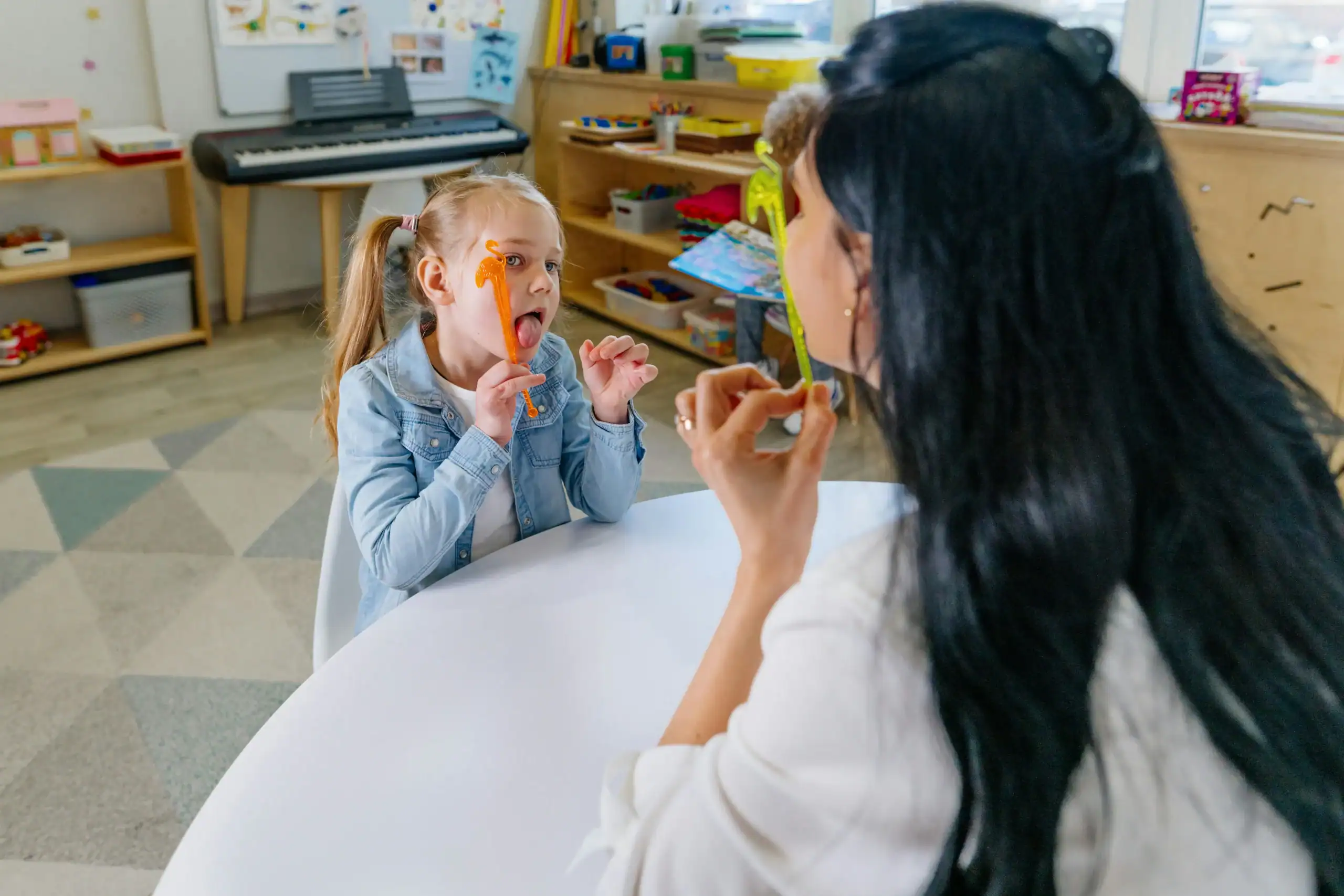 Child practicing tongue exercises for oral motor dysfunction therapy