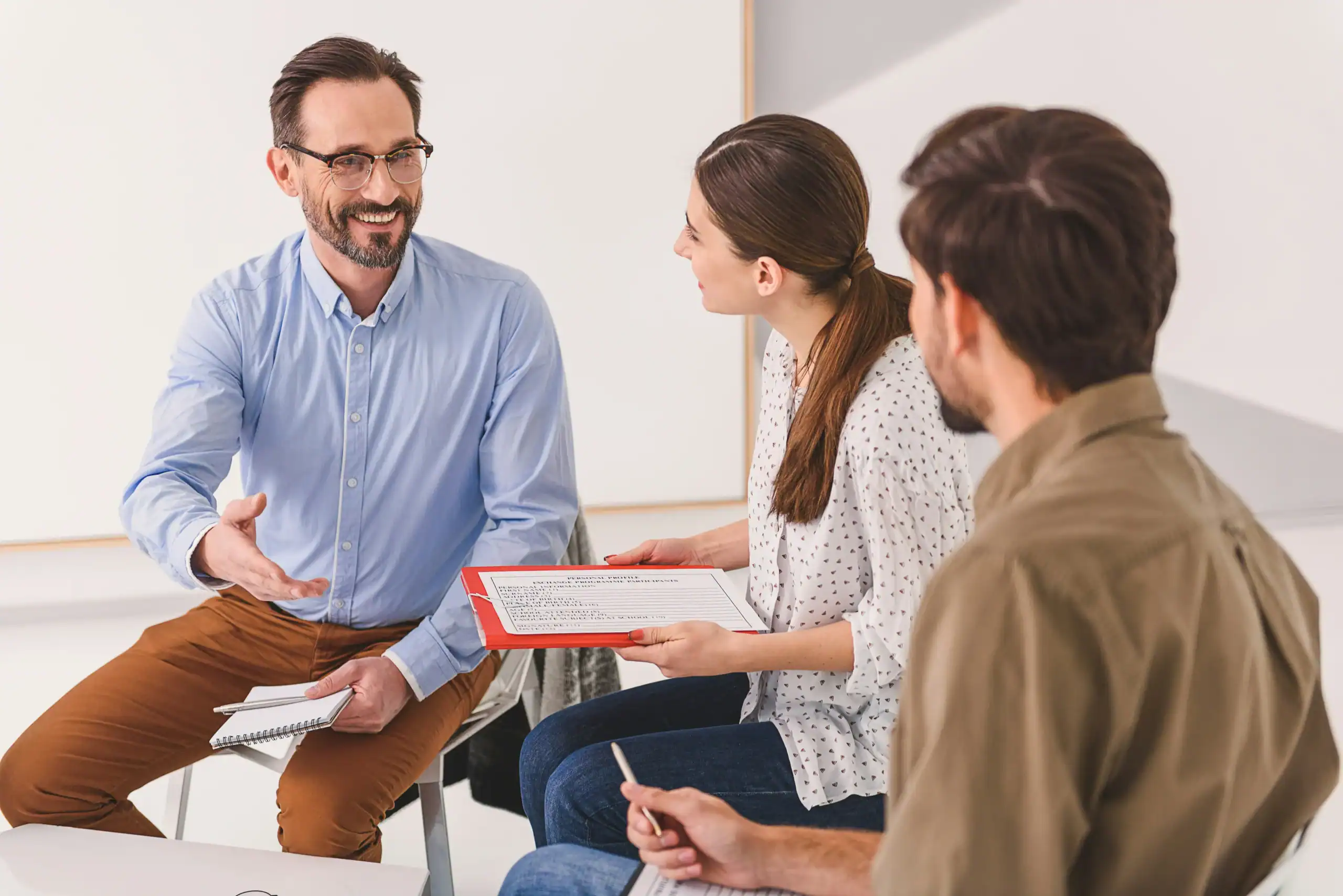 Estate planning advisor meeting with parents about special needs financial strategies. Estate planning advisor meeting with parents about special needs financial strategies.