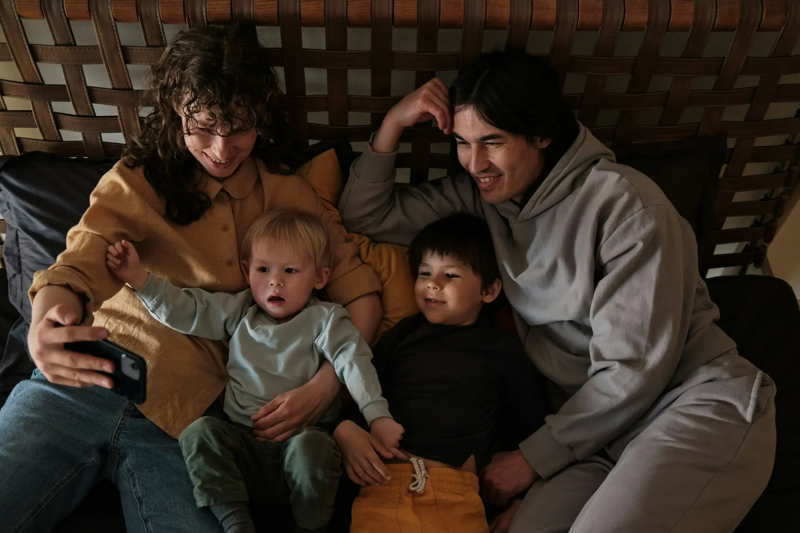 Family relaxing and watching educational videos through autism apps for parents and kids.