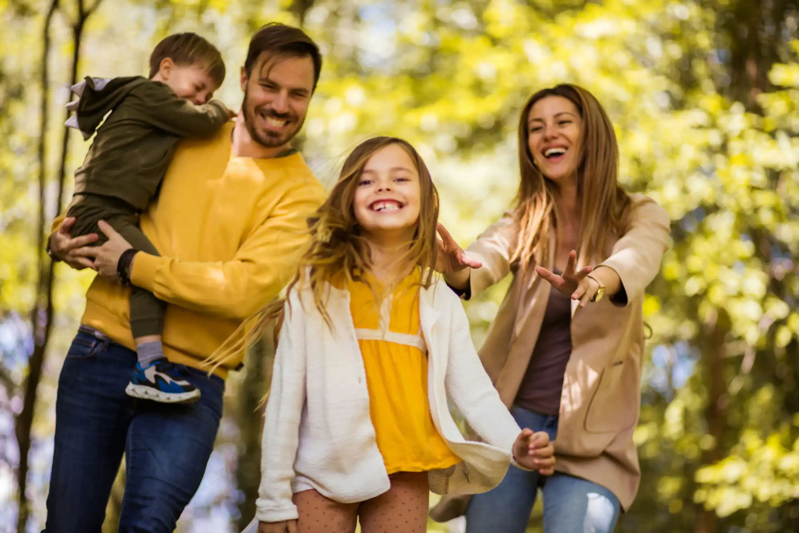 Happy family outdoors after child’s progress in oral motor therapy