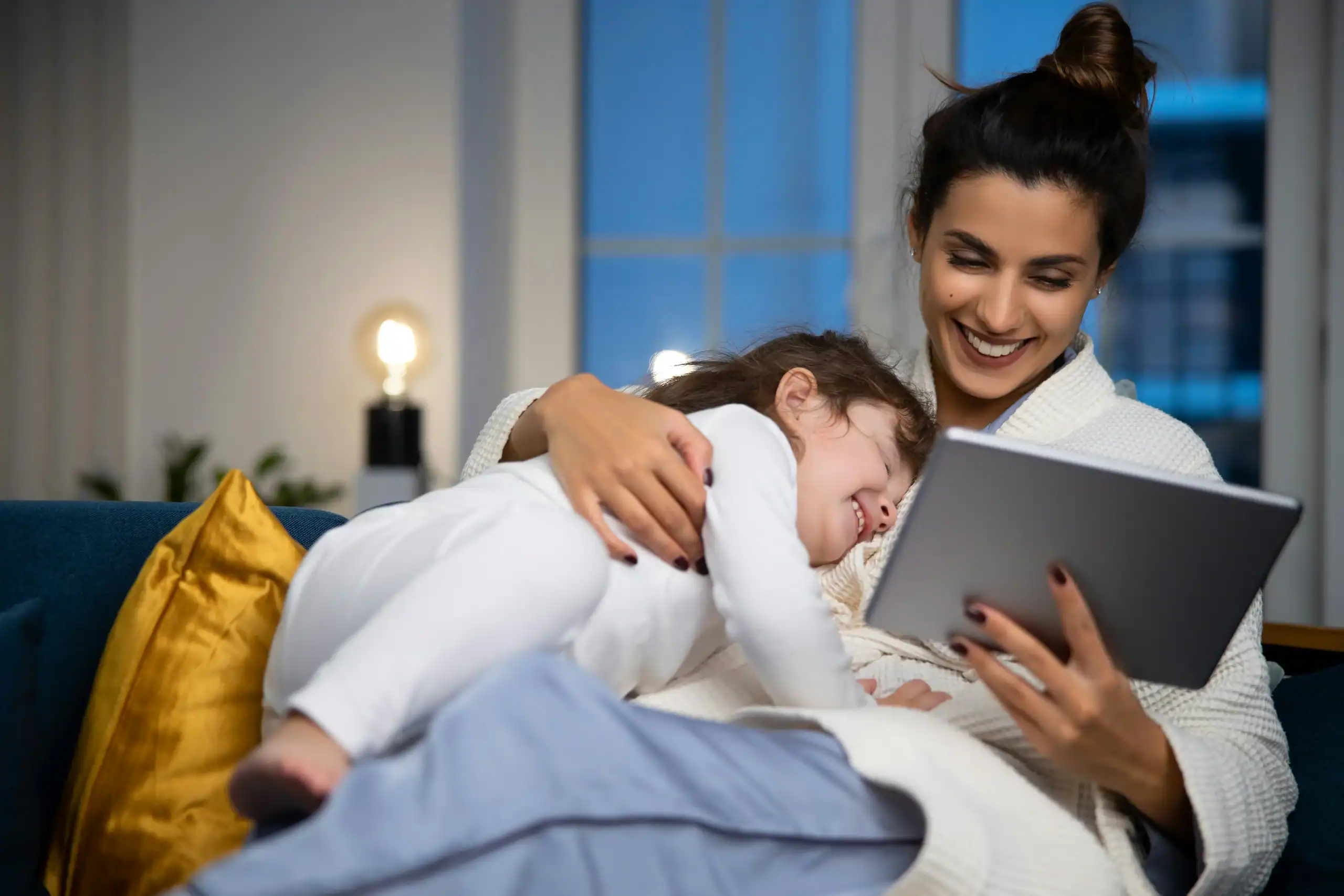 Parent and child bonding with calming screen time after managing autism behavior triggers. Parent and child bonding with calming screen time after managing autism behavior triggers.