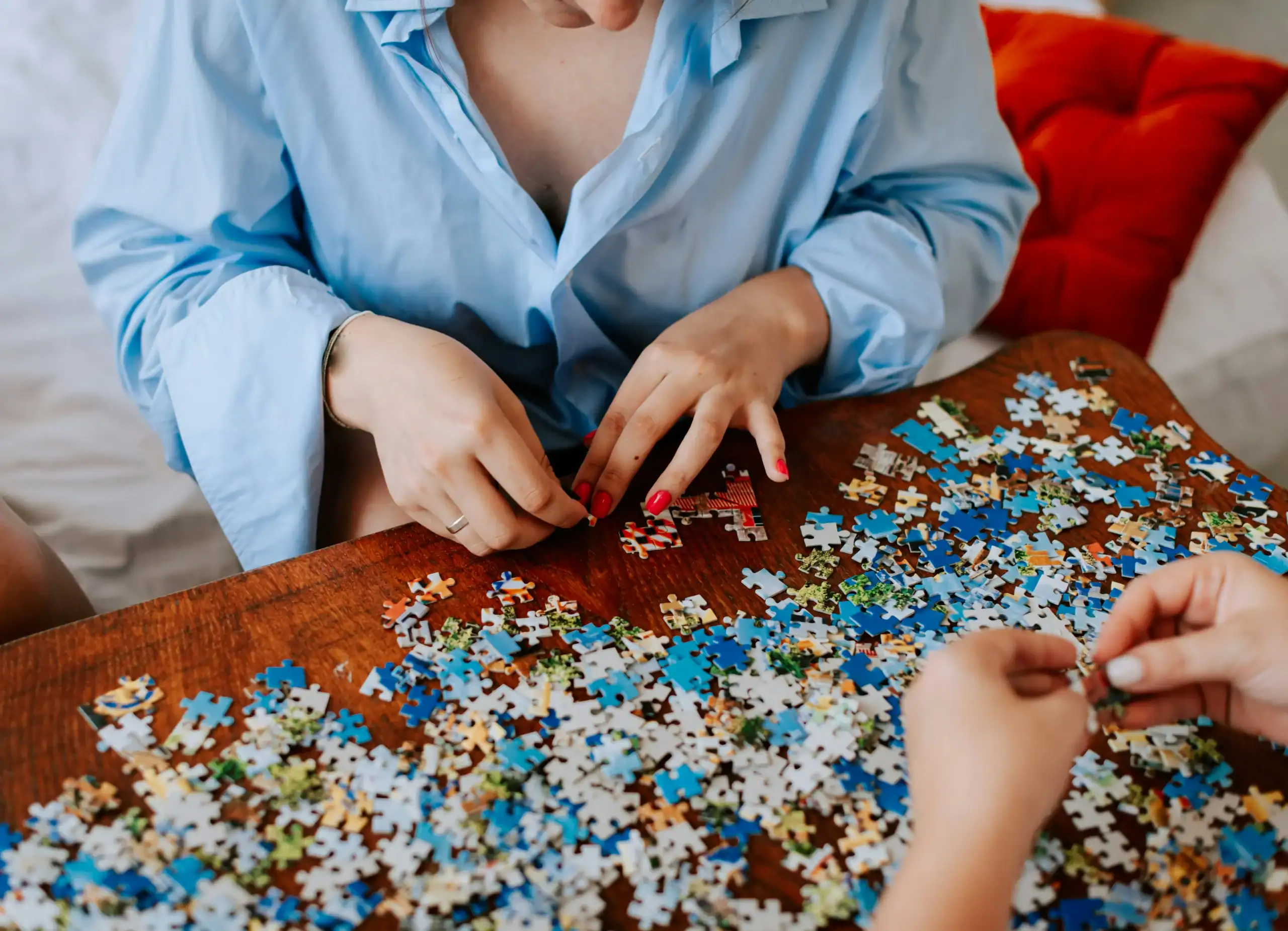Adults completing a puzzle, a relaxing and engaging gift for autistic adults. Adults completing a puzzle, a relaxing and engaging gift for autistic adults.