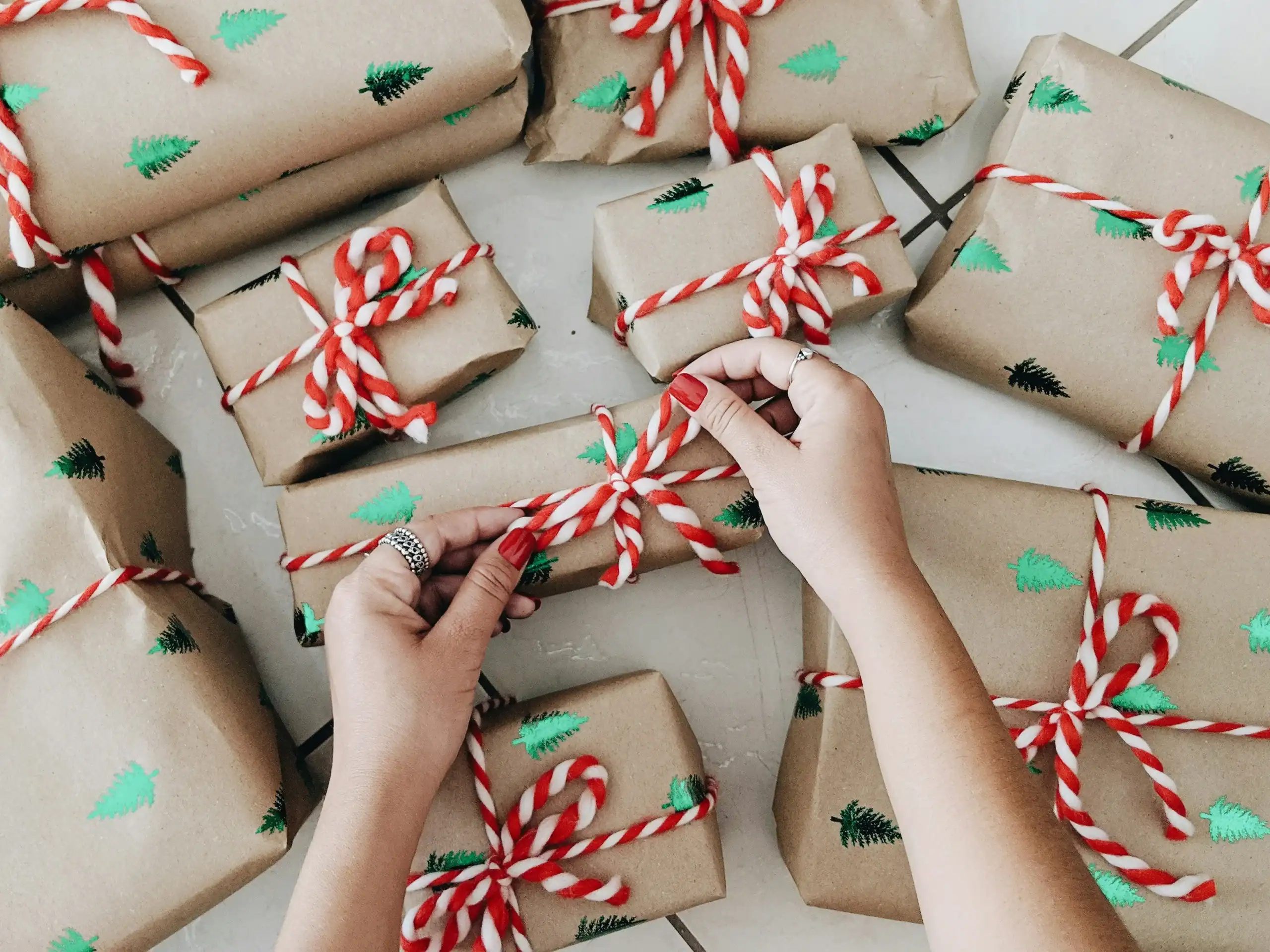 Person wrapping Christmas presents, preparing thoughtful gifts for autistic adults. Person wrapping Christmas presents, preparing thoughtful gifts for autistic adults.