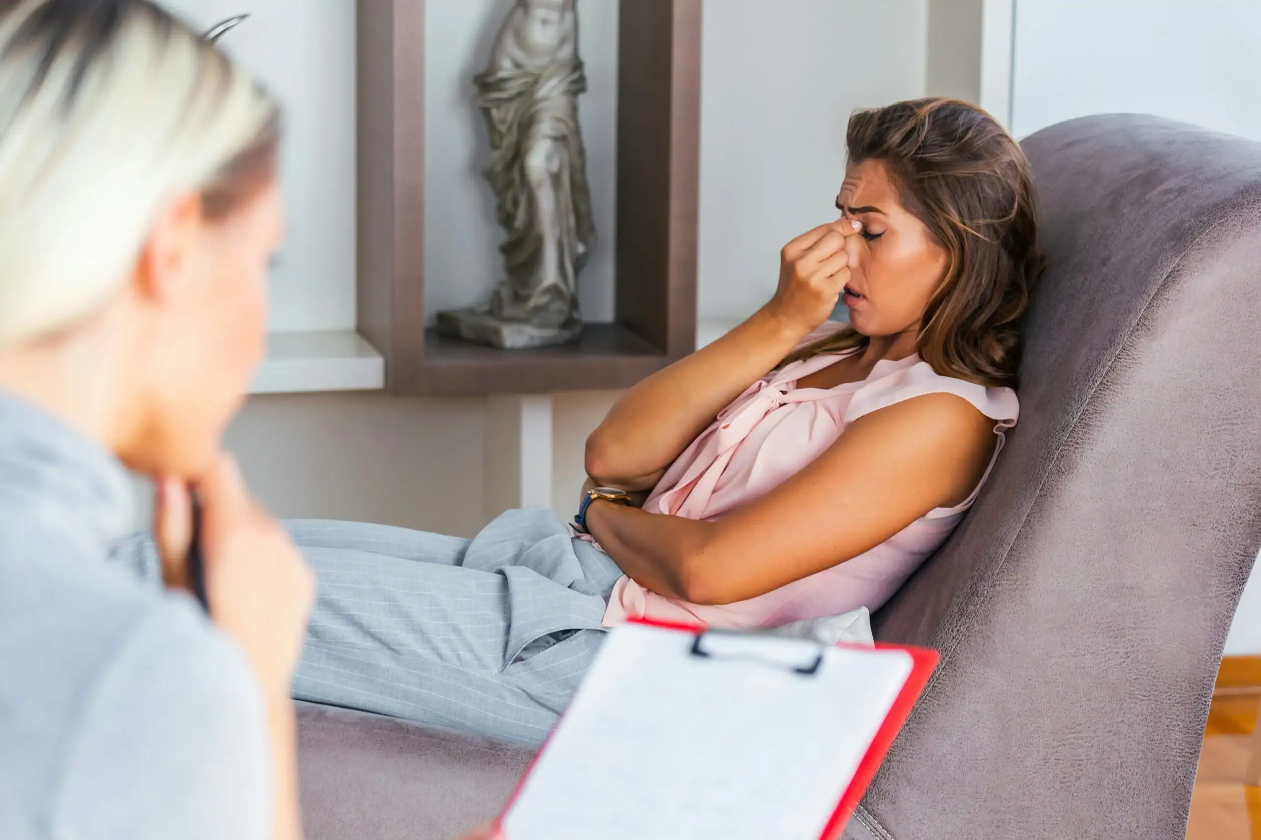 Woman discussing emotional overload with a therapist during a counseling session.