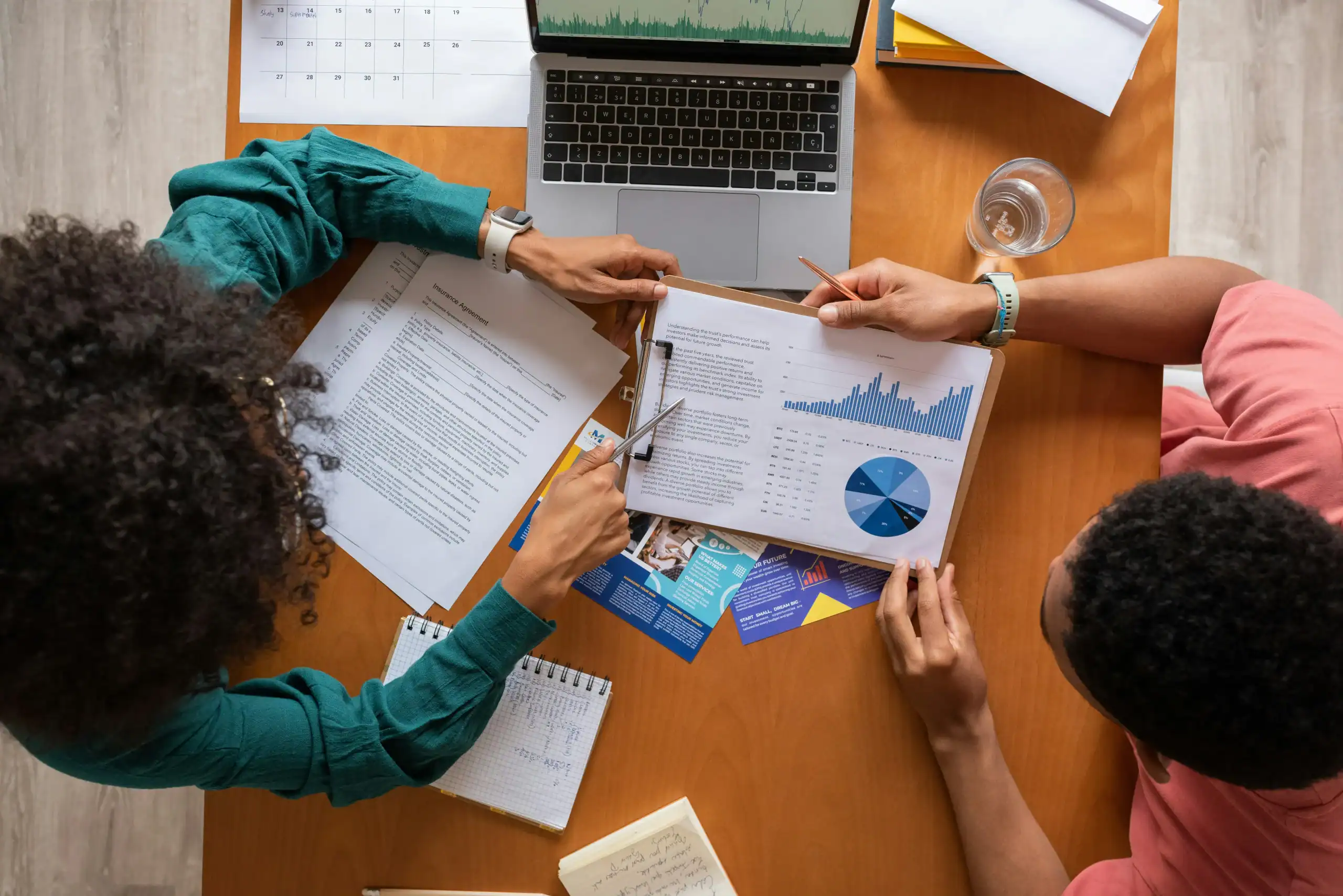Photo of overhead view of professionals reviewing financial documents tied to life insurance for special needs child