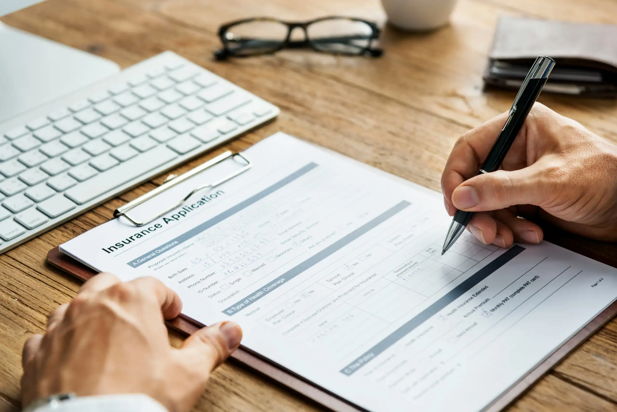 photo of person completing insurance paperwork for life insurance for parents of special needs child